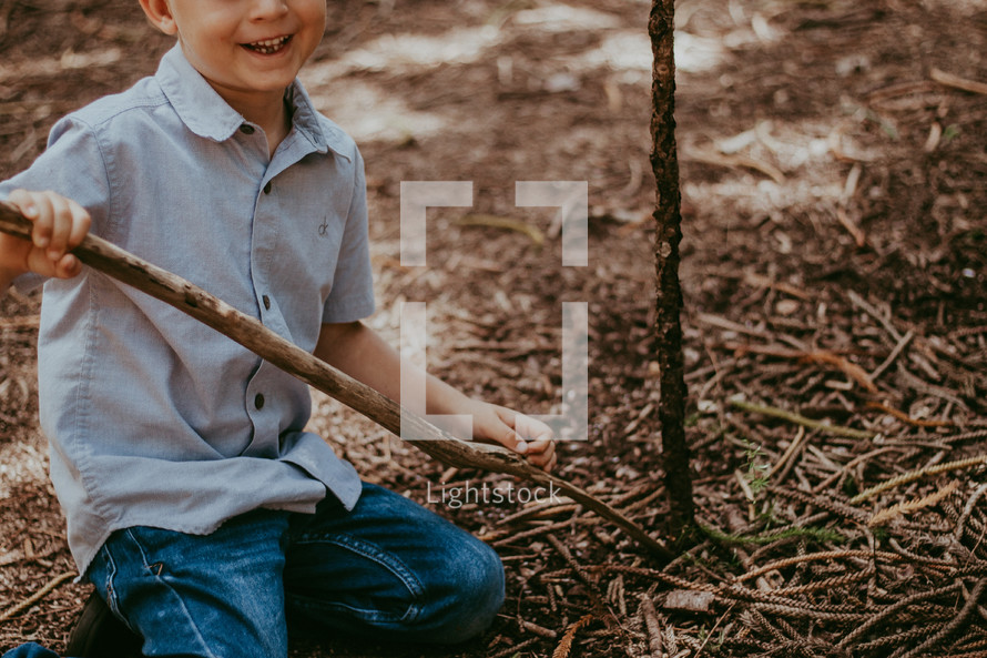 a boy playing with sticks 
