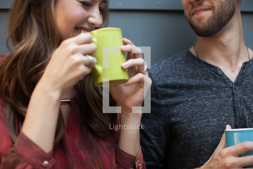 Husband and wife drinking coffee together.