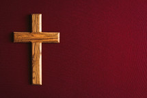 olive wood cross on a red background 