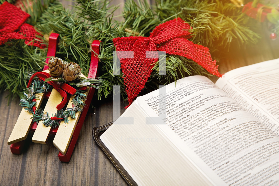 Christmas wreath and open Bible 