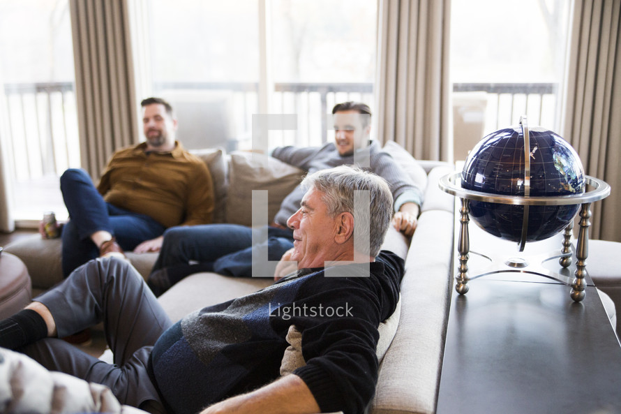 men sitting on a couch 