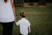 mother and son walking hand in hand 