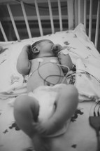 a newborn in a hospital nursery 