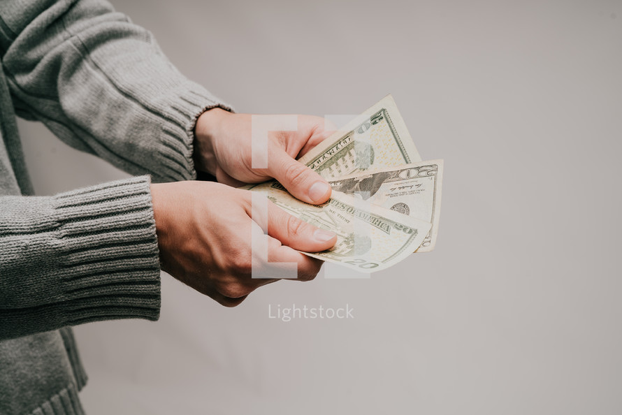 a man holding out cash 