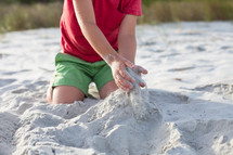 boy child playing in the sand 