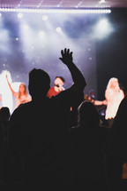 hands raised at worship service 