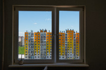 tall yellow, orange, and white apartment buildings 