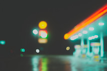 neon lights of a gas station at night 