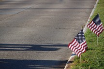 American flags along a curb of a street 