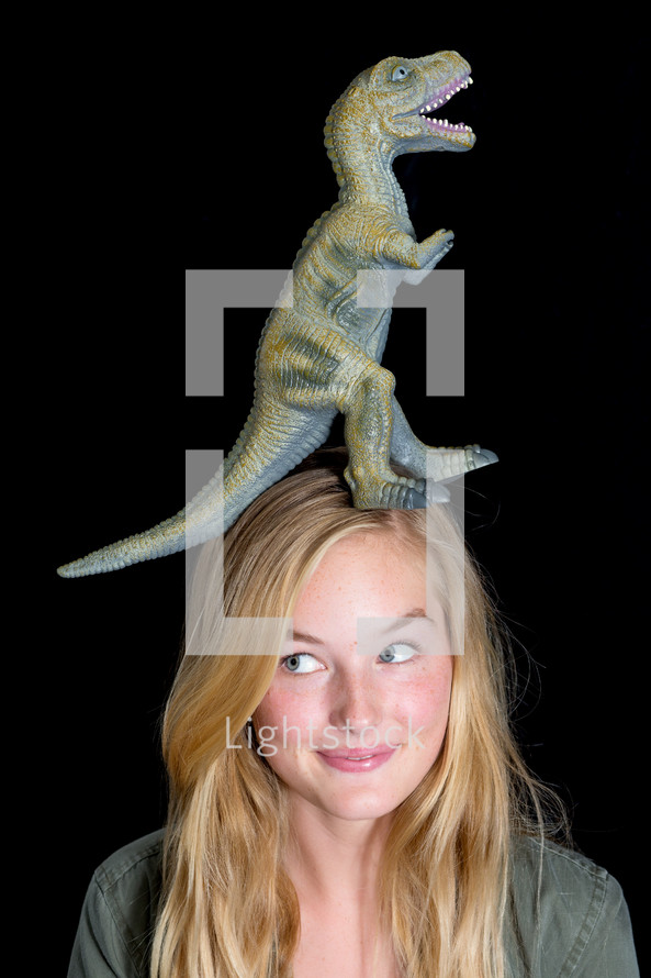 Dinosaur on a girl's head.