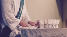 A Catholic deacon preparing the blessed sacraments for the Eucharist 