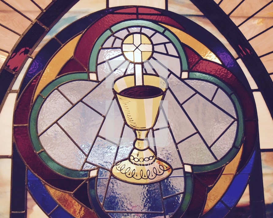 A stained glass window depicting the Eucharist 