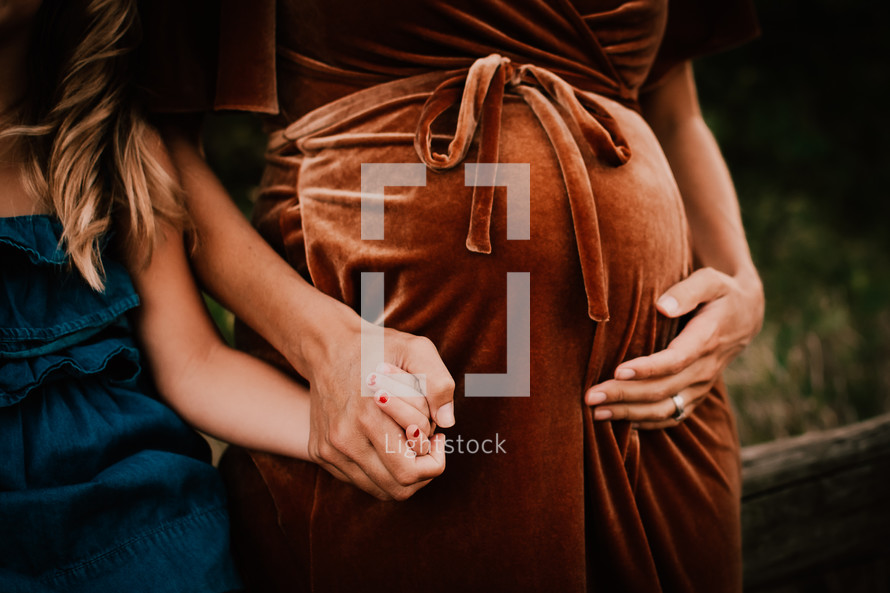 Maternity shot of daughter and pregnant mother