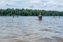 people swimming in a lake in summer 