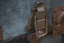 old latch on a rusty trunk 