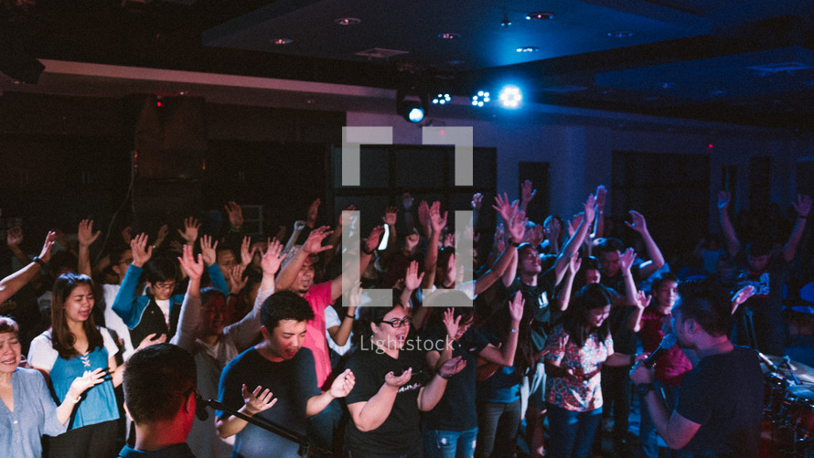 raised hands of praise during a worship service 