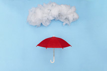red umbrella under a cloud 
