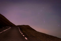 mountain road at the edge of a cliff at night 