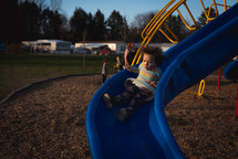 toddler going down a slide 