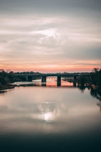 bridge over a river at sunset 