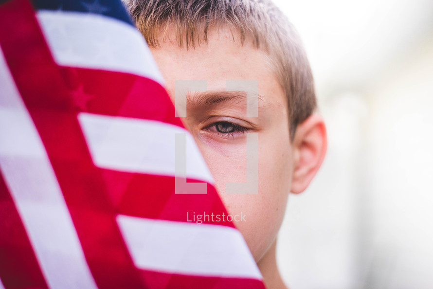 boy holding an American flag 
