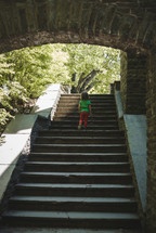 toddler girl exploring stone steps 