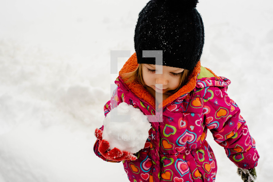 a child building a snowman 