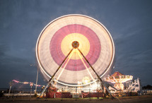 Ferris wheel in motion at an amusement park.