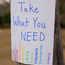 Take What You Need flyer attached to a telephone phone 