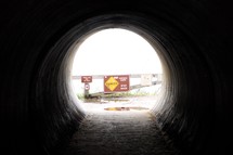 danger sign at the end of a tunnel 