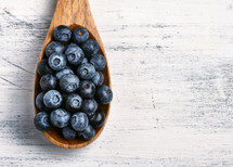 blueberries in a wooden spoon 
