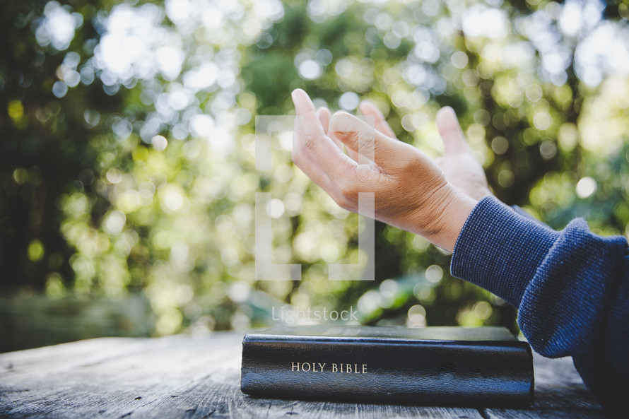 Asian woman with her Bible and hands open