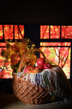 Autumn Basket at Window and red trees in background