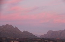 pink sky over mountains at sunset 