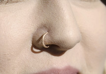 A woman's nose with a nose piercing 