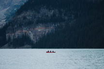 paddling a canoe on a mountain lake 