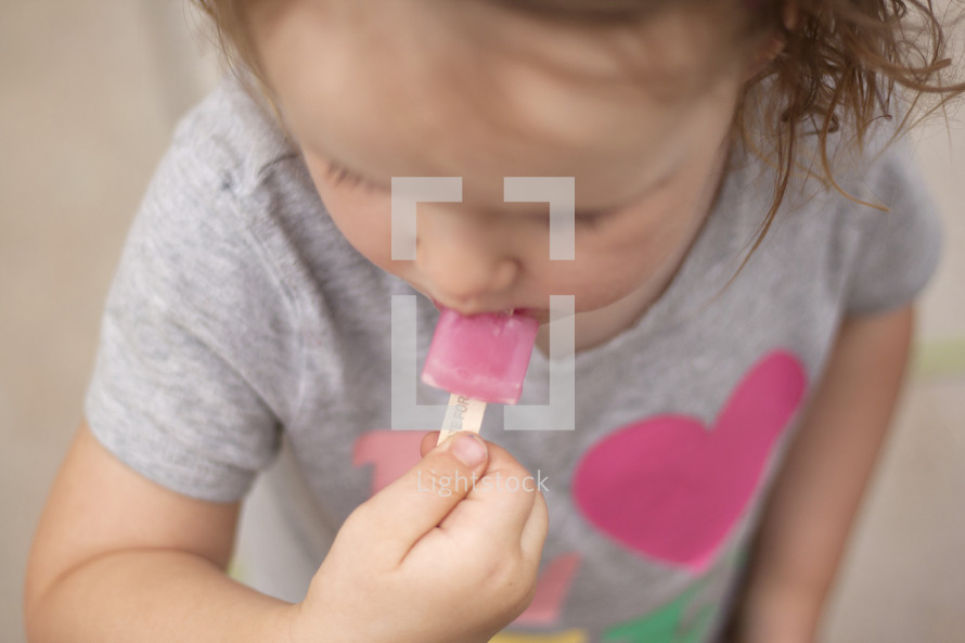 toddler eating a popsicle 