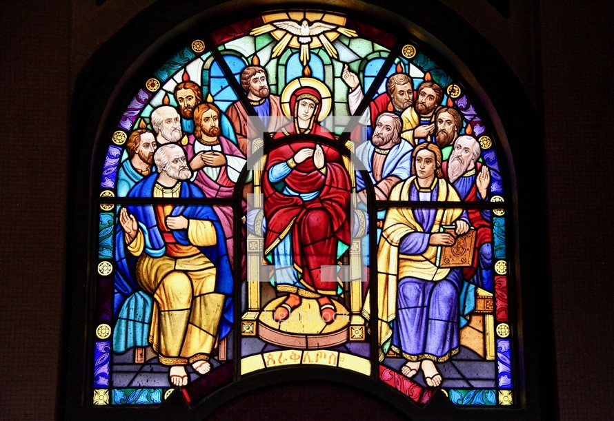 Stained glass window depicting the 12 disciples and Mary, mother of Jesus