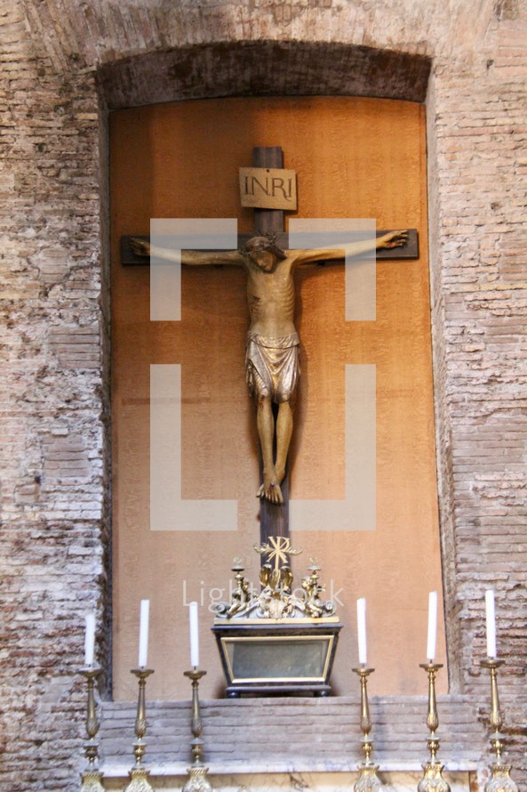 crucifix above an altar 