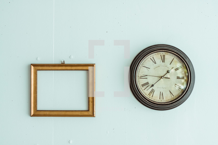 empty frame and clock on a wall 