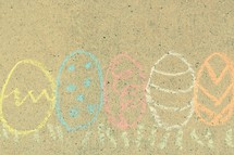 Easter eggs in grass border in sidewalk chalk 