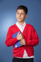 a boy student holding a book