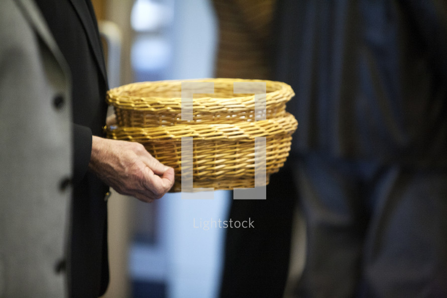 man carrying offering baskets 