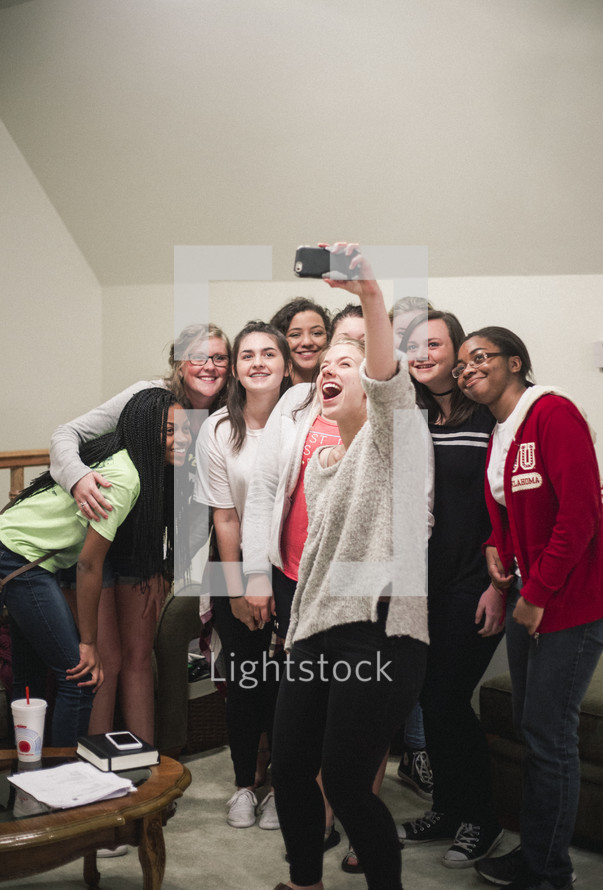 friends taking a group selfie 