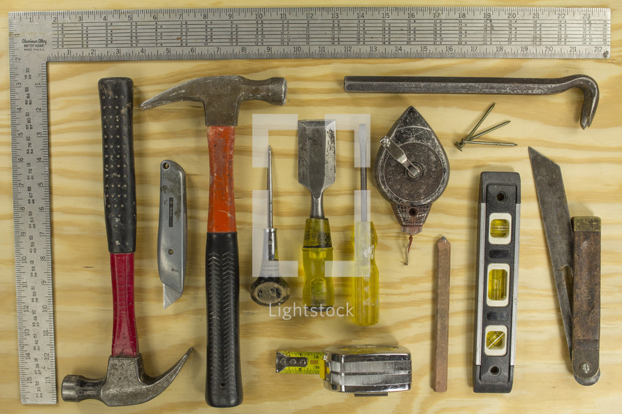 A flat lay of common carpentry tools