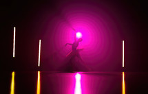 Beautiful silhouette of ballerina on pink background dancing ballet. Woman performs smooth movements. Sensual dancer in tutu dress on scene under neon light.