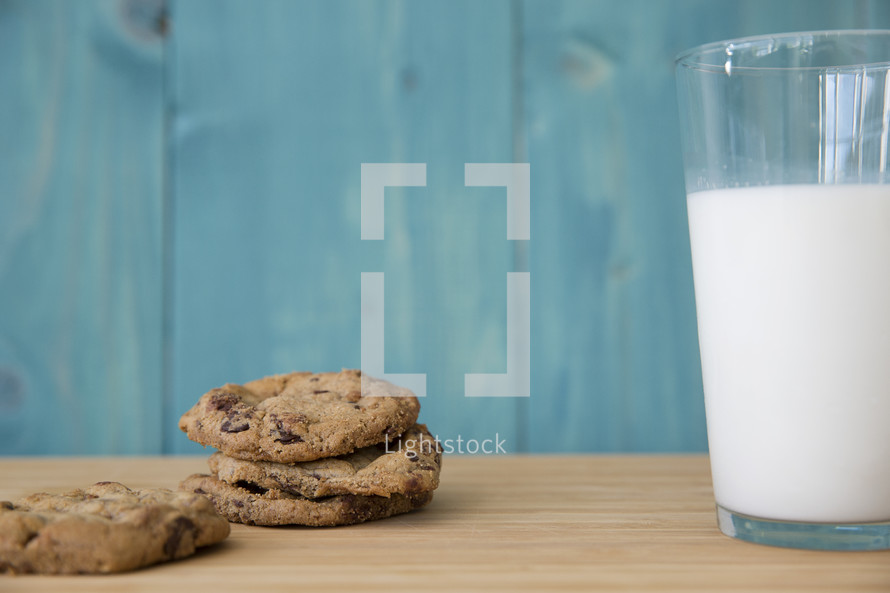 cookies and milk on a wood table.