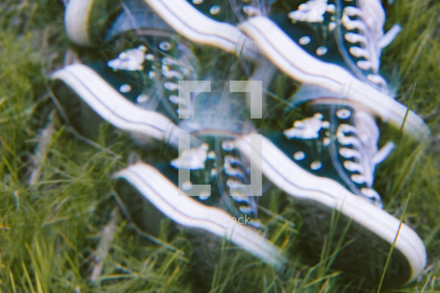 converse sneakers in grass multiple exposure 