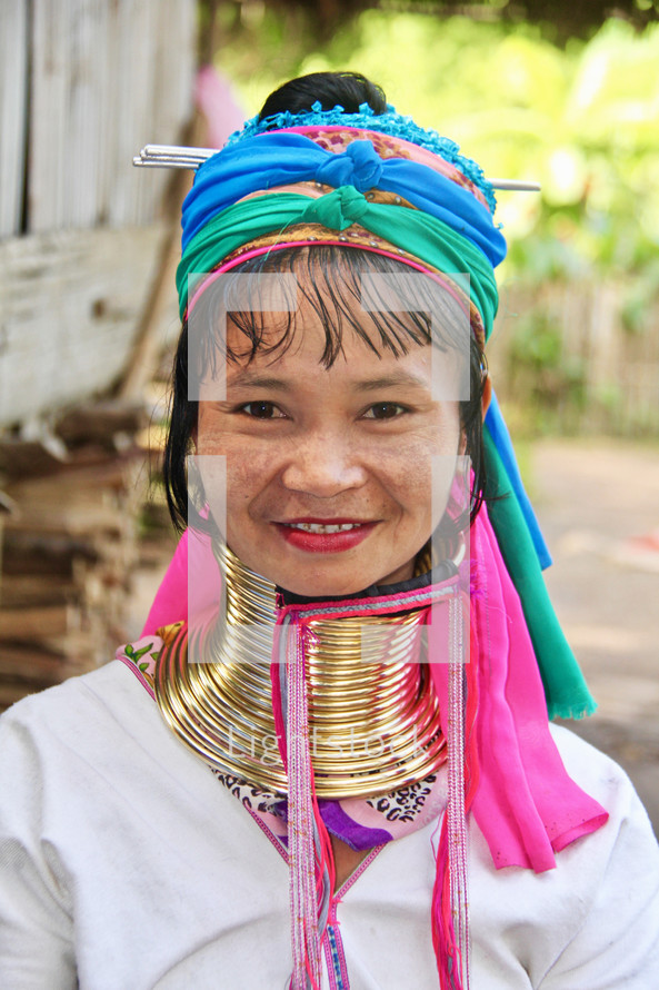 a woman with gold rings around her neck 