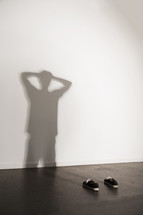 shadow of a man not present with hands up in exhaustion. 
